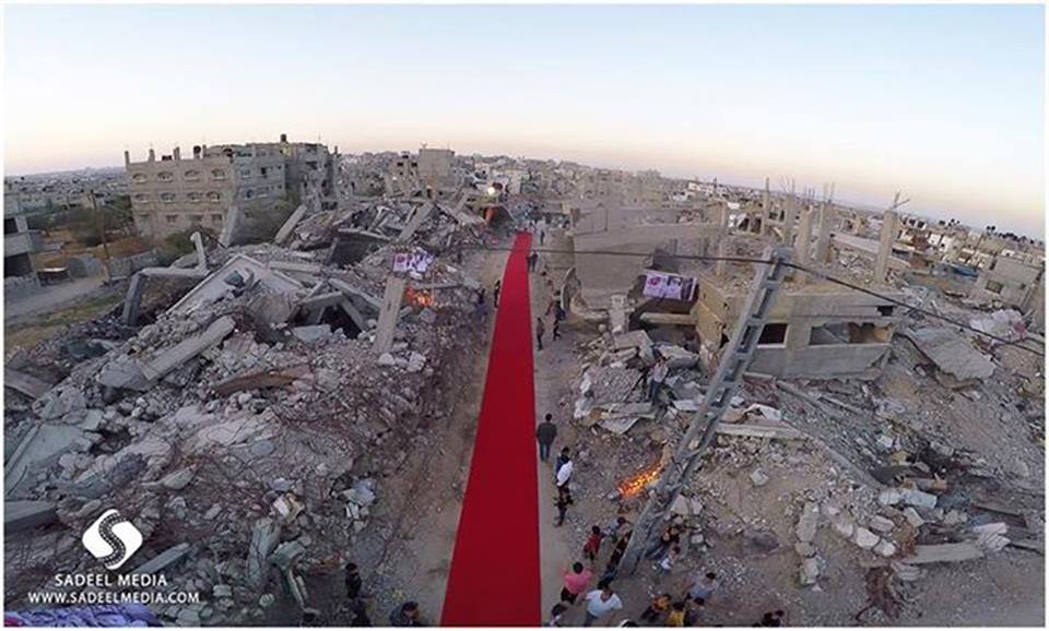 The red carpet is rolled out, surrounded by the destruction wrought upon Gaza (Source: Karam Gaza Film Festival Facebook Page)
