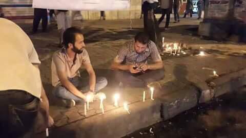 Iraqis light candles at the site of last night's blast, which claimed the lives of 17 people in Karrada, including pioneer journalist Ammar Al Shahbander