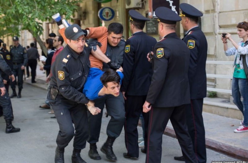 Police in Azerbaijan detain a young man. Photo by Radio Free Europe/Radio Liberty, reused with permission.
