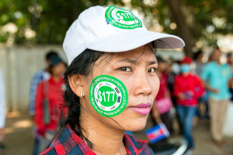 A worker wearing a sticker that features the logos of major apparel brands, including H&M, Walmart, Levi’s, Gap Puma, C&A, Adidas and Zara, that outsource their production in factories in Cambodia. Photo from the Facebook page of Licadho, a human rights group 