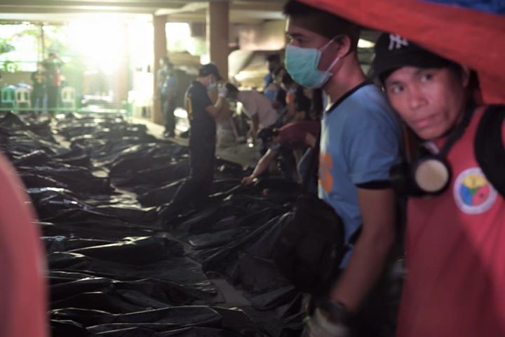 Relatives of Kentex factory fire victims wait in line to view the bodies hoping they will be able to identify their loved ones. According to Valenzuela City's PIO, the bodies are beyond recognition. Photo Credits: Tudla Productions.