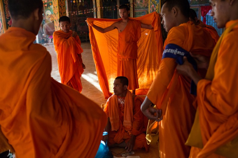 Monks get ready on day four of a ten day Human Rights march into Phnom Penh on National Road 6. After the Cambodia's general elections in July 2013, groups of Monks took an active roll in politics and promoting Human Rights. Photo and caption by Nicolas Axelrod (12/4/2013)