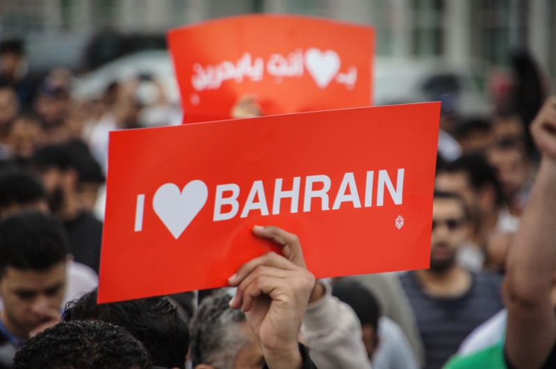A protestor carrying a I love Bahrain placard during a rally in Bahrain in 2013. Photograph by Moh'd Saeed. Copyright: Demotix 