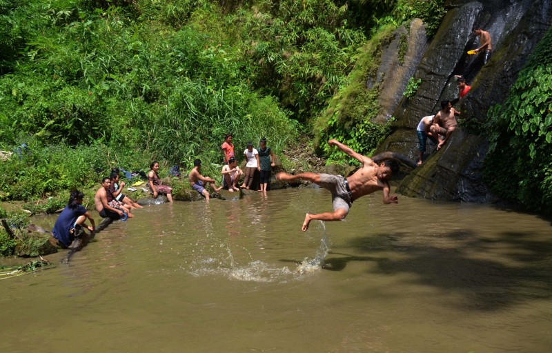 An Naga youth jump into the water to cool off beside a small stream on a hot summer day in the outskirt of Dimapur, Nagaland, India. Image by Caisii Mao. Copyright Demotix (23/5/2015)