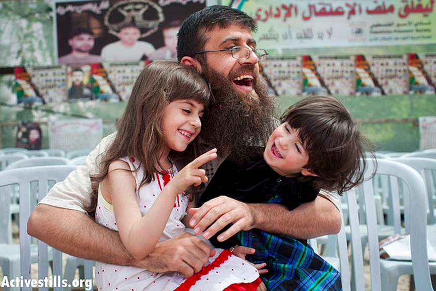 Khader Adnan plays with his daughters on his first day out of Israeli jail in the West Bank village of Araba, near Jenin, April 18, 2012. (Photo: Activestills/ Oren Ziv)