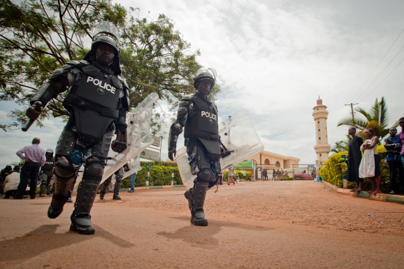 Kampala, Uganda. 27 April 2012 -- Riot police walk past the entrance to the Gaddafi National Mosque in Old Kampala. Photo by Will Boase. Copyright Demotix