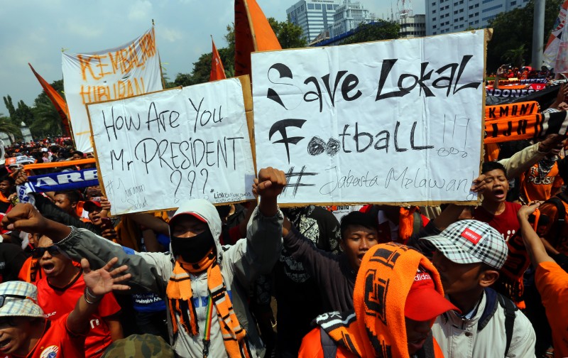 Supporters of football club Persija rally holding signs demanding presidential intervention to roll out the Indonesian Super League affected by the decision of the government to suspend the local football association (PSSI). Photo by Denny Pohan, Copyright @Demotix (5/5/2015)