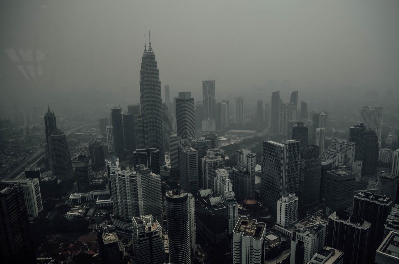 Malaysia's Petronas Twin Towers and surrounding buildings are seen shrouded in a thick haze in Kuala Lumpur, Malaysia, from forest fires in the region. Photo by Muhammad Shafiq Mohd Zain, Copyright @Demotix (9/12/2015)