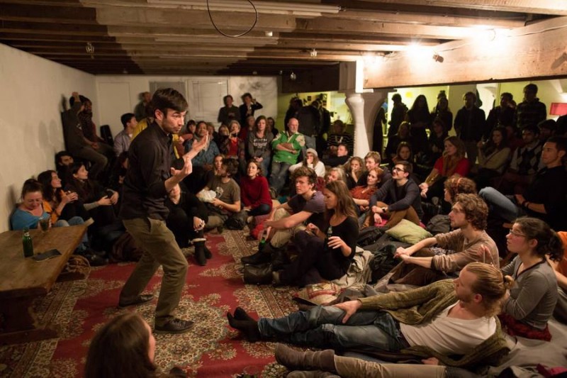 "Ryan Millar warming up the crowd for the storytellers." Picture taken by Bas Uterwijk in 2013 and available on the Mezrab's Facebook page.